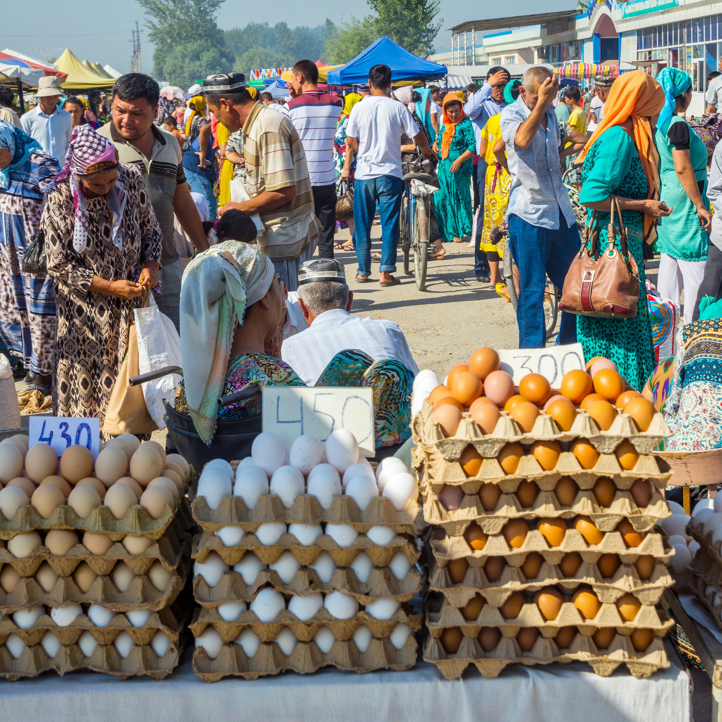 Eggs for sale and a crowd of people visiting Kumtepa bazaar. 